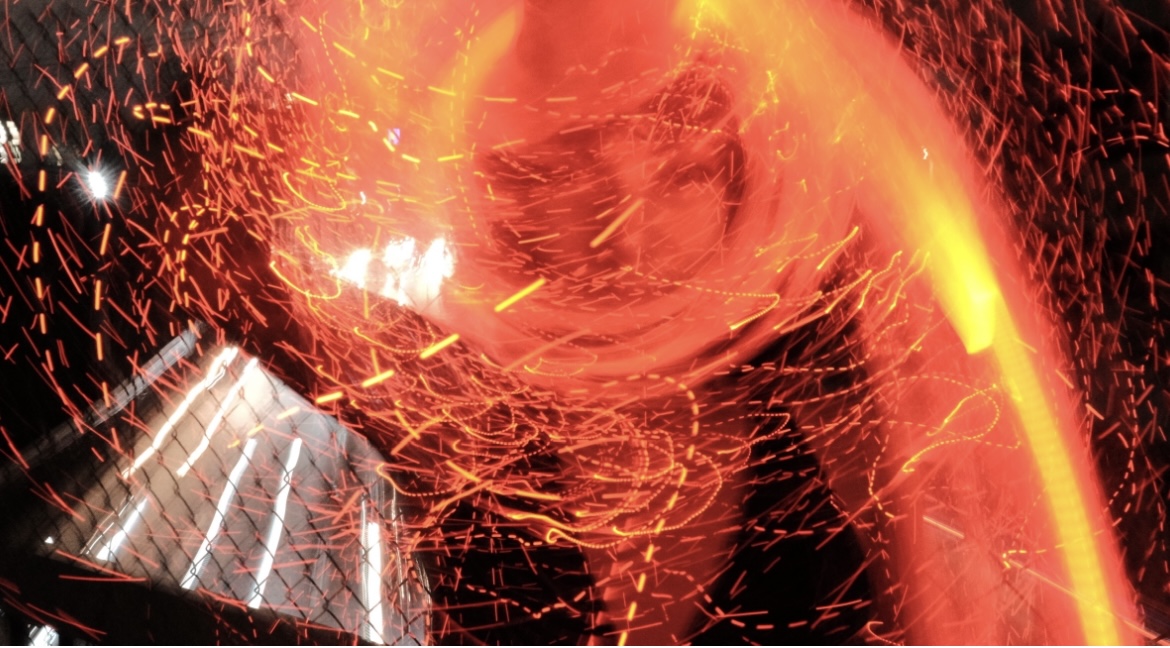 Sweeping orange and red LED light trails resembling fire and sparks